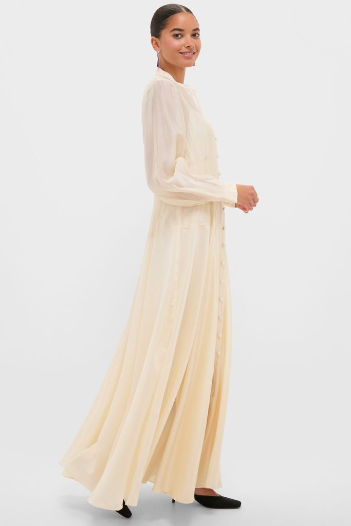Woman in profile wearing the Champagne Organza Marbella Dress, a classic, high-end piece with blouson sleeves and pintucks, exuding effortless elegance and fun sophistication.