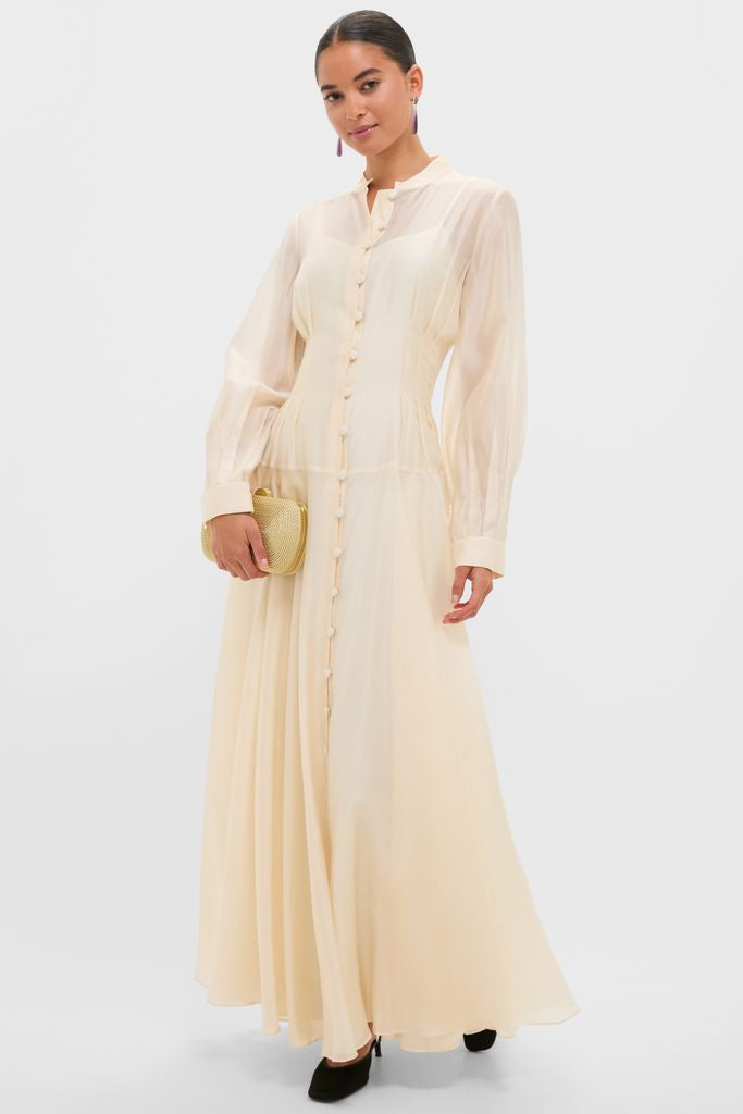 Champagne Organza Marbella Dress exudes classic elegance with sheer blouson sleeves, pintuck bodice, and Mandarin collar, creating an effortless, high-end look perfect for fun occasions.