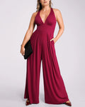 Model wearing deep V jumpsuit with built-in shaping support and flattering silhouette